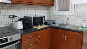 A kitchen with a microwave, toaster, and sink. - "Your Home @Acropolis Museum" by YHA (ΑΘΗΝΑΙΩΝ)
