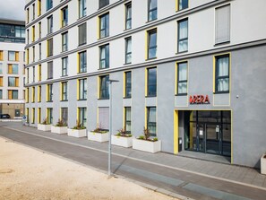 A multi-story building with a modern design, featuring a prominent 'BREA' sign on the ground floor. - Brera Serviced Apartments Ulm (Ulm)
