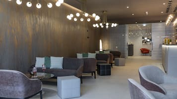 A modern interior with sofas, a coffee table, and a bar area.