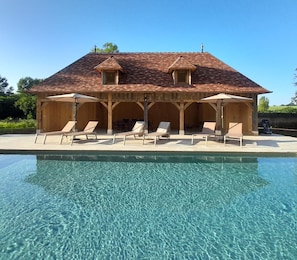 Seasonal outdoor pool, open 10:00 AM to 7:00 PM, pool umbrellas