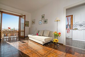 Family Apartment, 2 Bedrooms, Mountainside (Balcone Panoramico sul Garda) | Living area | Flat-screen TV