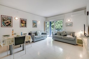 Family Apartment, 1 Bedroom, Lakeside (Residenza Lago D'Argento) | Living room | Flat-screen TV