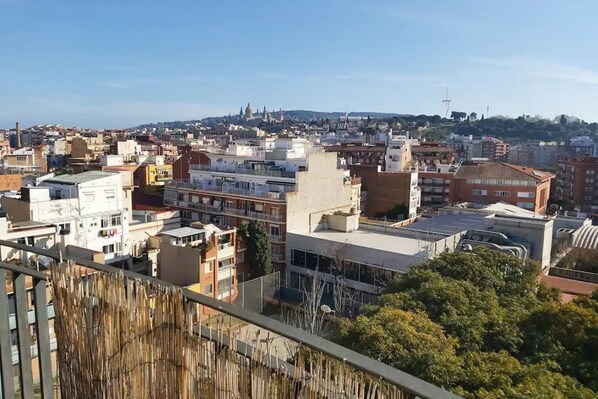 A cityscape with various buildings, including a prominent dome structure in the distance.