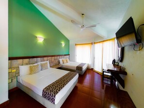 A hotel room with two beds, a ceiling fan, a TV, and a desk with a phone. - Hotel Casa Arena (Zihuatanejo)