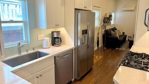 A modern kitchen with stainless steel appliances, a dishwasher, and a coffee maker.