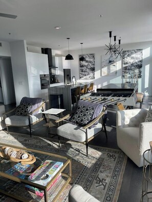 A modern living room with a sofa, armchairs, a coffee table, and a rug. - Luxury Penthouse 2 Blocks | Near UT Stadium (Austin)