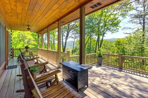 A wooden deck with outdoor seating, a grill, and a view of a forested area. - 2 Queen Suites, Trail Access, Mtn View, Fire Table (Blue Ridge)