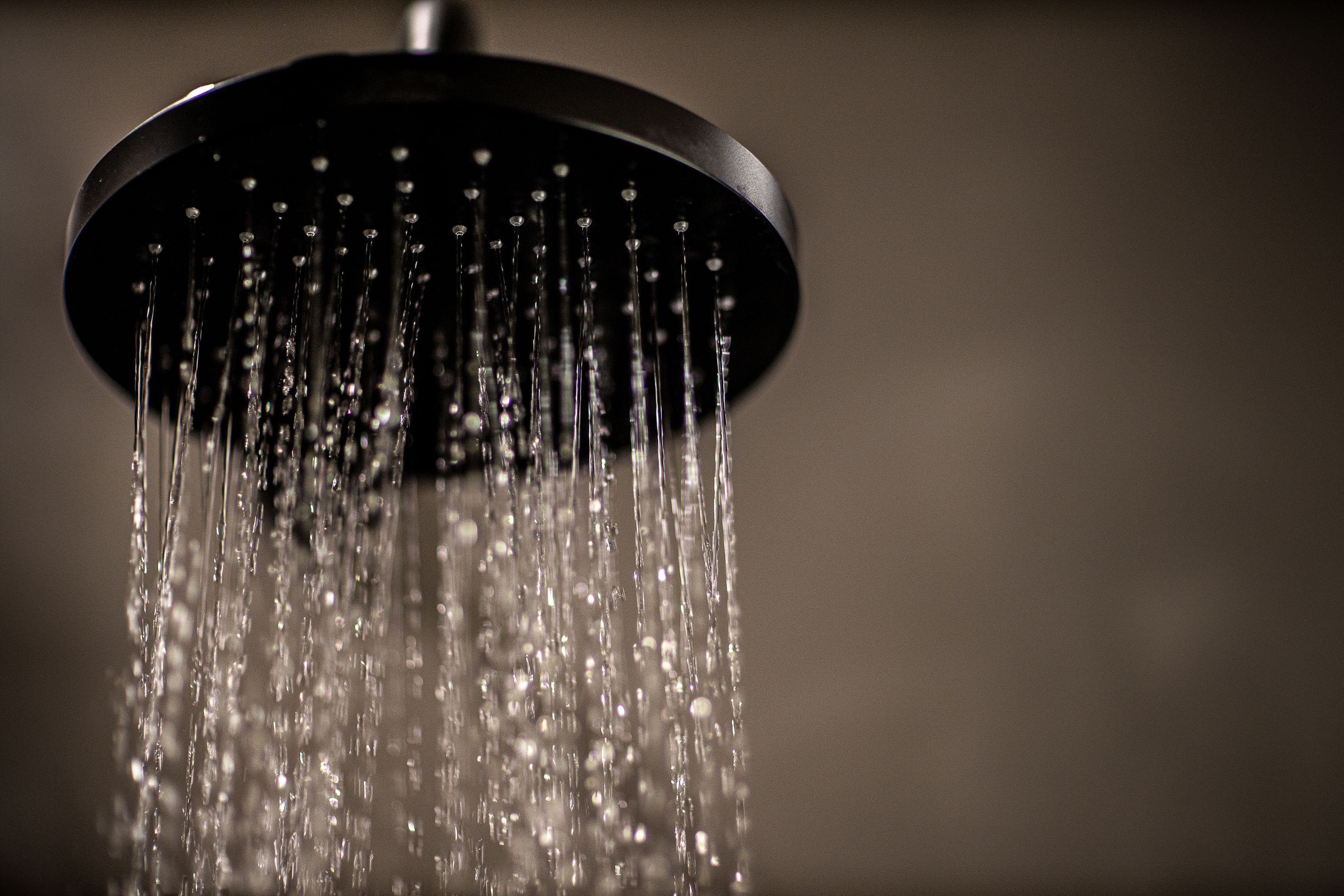 A showerhead with water flowing down.