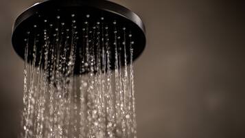 A showerhead with water flowing down.