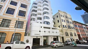 A modern hotel with a unique architectural design, featuring multiple balconies and a prominent entrance. - Tuynhuys (Cape Town)