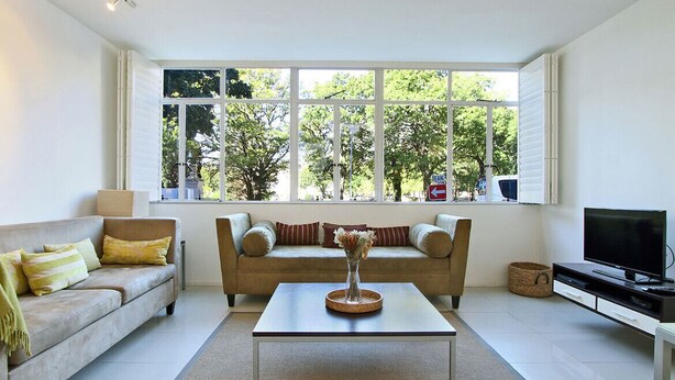 A living room with a sofa, coffee table, and TV.