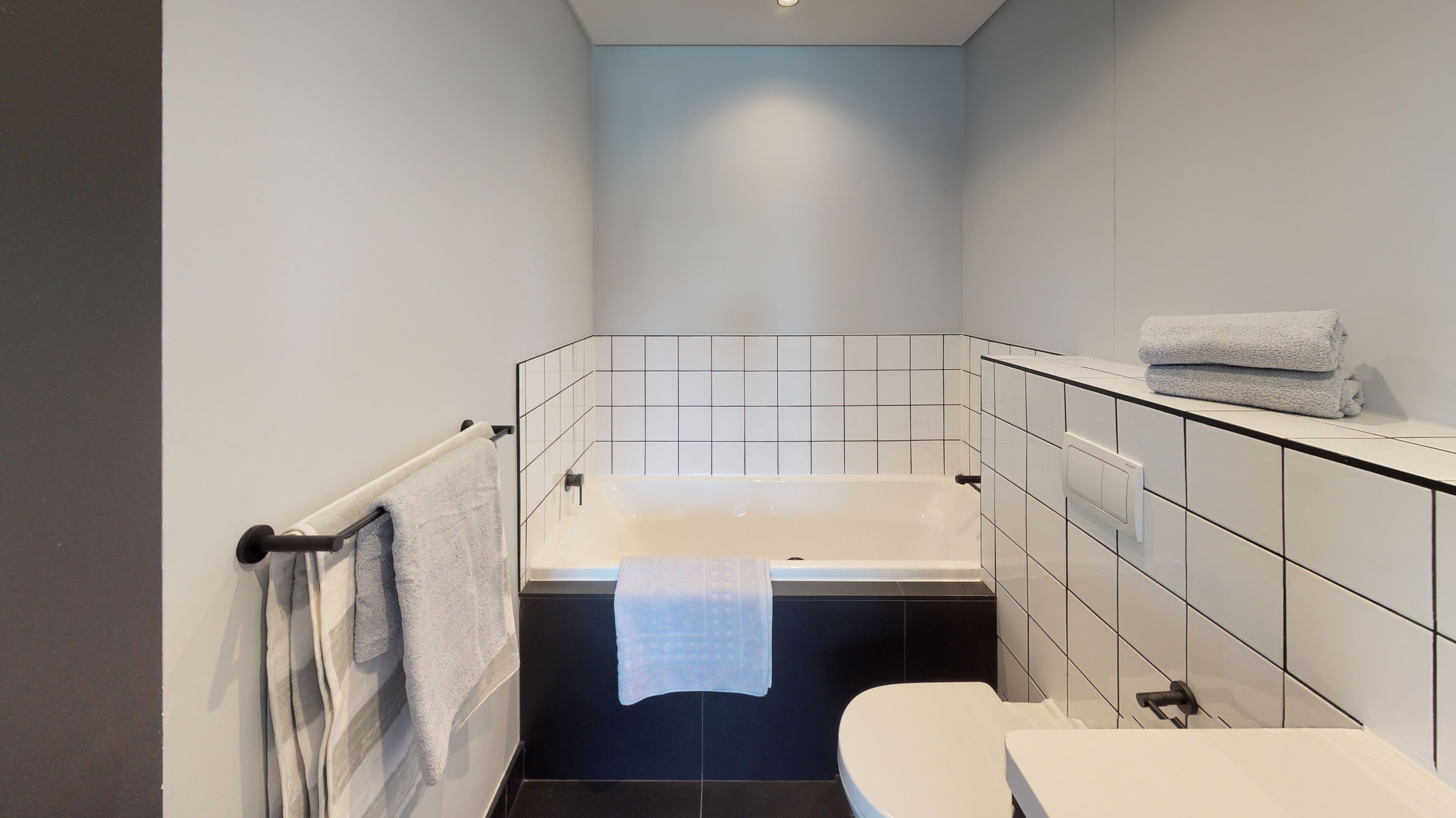 Une salle de bain moderne avec une baignoire, des toilettes et un lavabo.