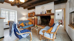 A cozy living room with wooden furniture, a fireplace, and a chandelier. - Tranquil Escape in Cendrieux (Val de Louyre et Caudeau)