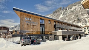 A modern building with a wooden facade and a sign reading 'residenz.' - Bright Mountain Retreat Near Wildkogel Gondola (Neukirchen am Grossvenediger)