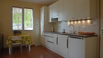 Villa | Private kitchen | Fridge, microwave, stovetop, high chair