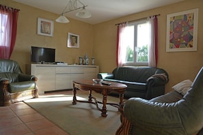 A living room with a television, sofa, and coffee table. - House in Piquecos With Private Pool & Garden (Piquecos)
