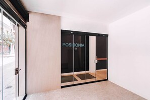 A modern hotel entrance with a glass door labeled "POSIDONIA." - GBH Hotel-Apartamentos Posidonia (Benidorm)