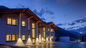 A modern two-story building with a flat roof and large windows, surrounded by a mountainous landscape. - Chalet in Gaschurn Near Ski Lift (Gaschurn)