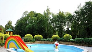 A swimming pool with a rainbow slide and a clown statue. - Chalet in Holiday Park With Private Terrace (Baarle-Nassau)