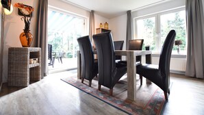 A dining area with a table, chairs, and a vase of flowers. - Alluring Holiday Home in Reutum-Weerselo with Hot Tub (Reutum)