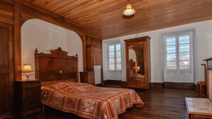 A room with a wooden bed, a dresser, a mirror, and a window with a view. - Vintage Retreat in Montfaucon (Montfaucon)