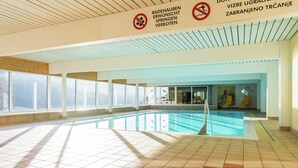An indoor swimming pool with tiled floors, large windows, and a sign prohibiting diving. - Apartment in Tauplitz Near Ski Lift (Bad Mitterndorf)