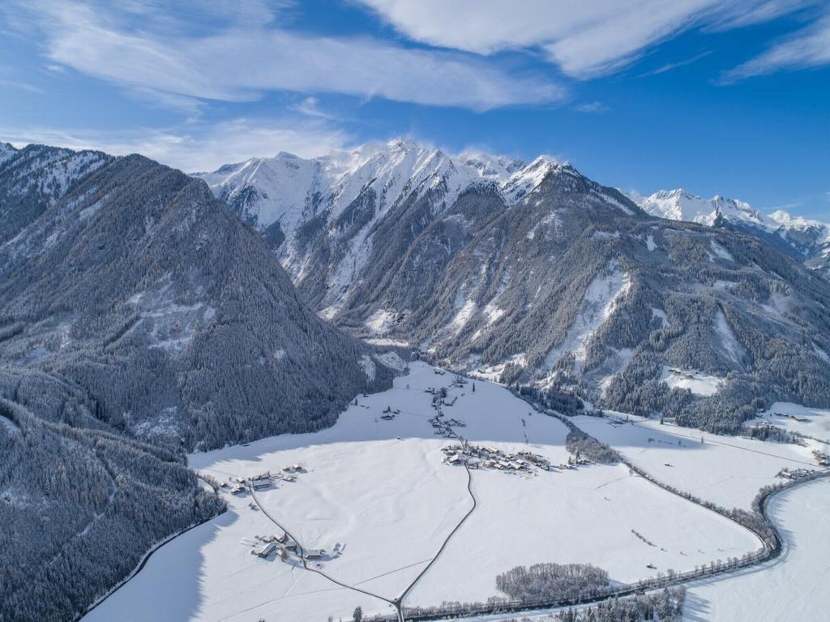 A snow-covered mountainous landscape with a clear sky.