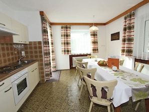 Enjoy a home-cooked meal in this well-equipped kitchen with modern appliances and adjacent dining area for two.
