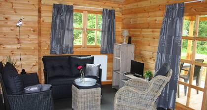 Wooden Cottage With a Veranda Located in a Natural Area
