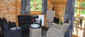 Wooden Cottage With a Veranda Located in a Natural Area
