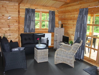 Wooden Cottage With a Veranda Located in a Natural Area