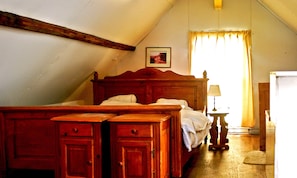 A bedroom with a wooden bed, a nightstand, a lamp, and a framed picture on the wall. - Luxury Mansion near Sea in Pingjum (Pingjum)