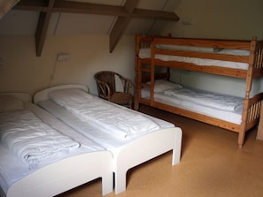 A dormitory room with two bunk beds, a single bed, and a chair. - Luxury Mansion near Sea in Pingjum (Pingjum)