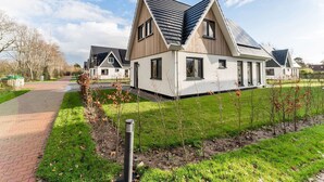 A modern residential complex with multiple houses featuring pitched roofs and large windows. - Holiday Home in De Koog With Sauna (De Koog)