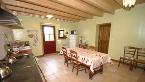 Une cuisine équipée d’une table à manger, de chaises et d’un réfrigérateur.