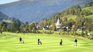 A golf course with a church and houses in the background. - Welcoming Apartment in Sankt Margarethen im Lungau near Ski Area (Sankt Margarethen im Lungau)