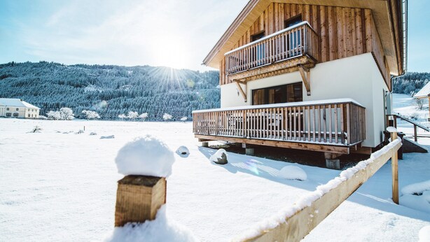 A wooden chalet with a balcony, surrounded by snow-covered landscape. - Classic Chalet With Infrared Sauna (Murau)