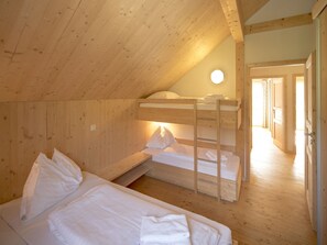 A cozy attic bedroom with bunk beds, wooden walls, and a skylight. - Pleasant Chalet With Whirlpool (Sankt Georgen am Kreischberg)