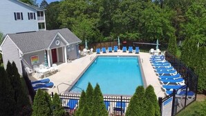 A rectangular swimming pool with a tiled deck, surrounded by blue lounge chairs. - 4BR 3.5BA POOL - Walk or bike to town and beach! (Rehoboth Beach)