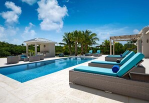 A heated pool, sun loungers