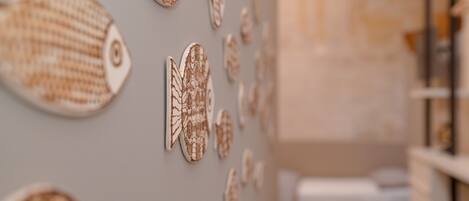 A wall with various fish-shaped decorations.