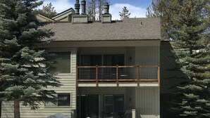 A two-story building with a balcony, a covered entryway, and a snow-covered driveway. - Shuttle Bus. Picturesque. King Bed. Updated. Parking (Keystone)