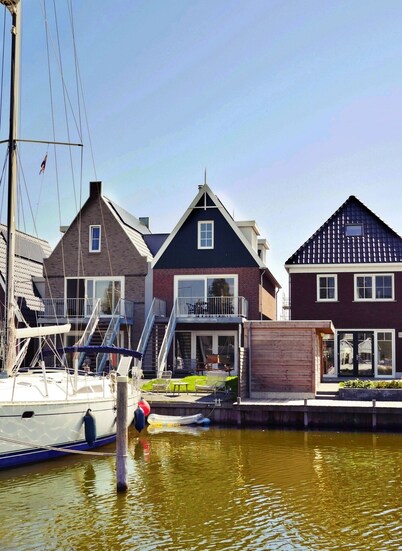 Modern house with high terrace & garden on private canal & jetty