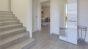 A modern interior with a staircase leading to a dining area and kitchen. - Stunning private villa for 6 guests with WIFI, A/C, private pool, TV and terrace (Porec)