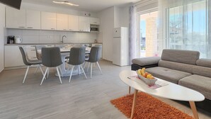 A modern apartment with a kitchen, dining area, and living room. - Stunning private villa for 6 guests with WIFI, A/C, private pool, TV and terrace (Porec)