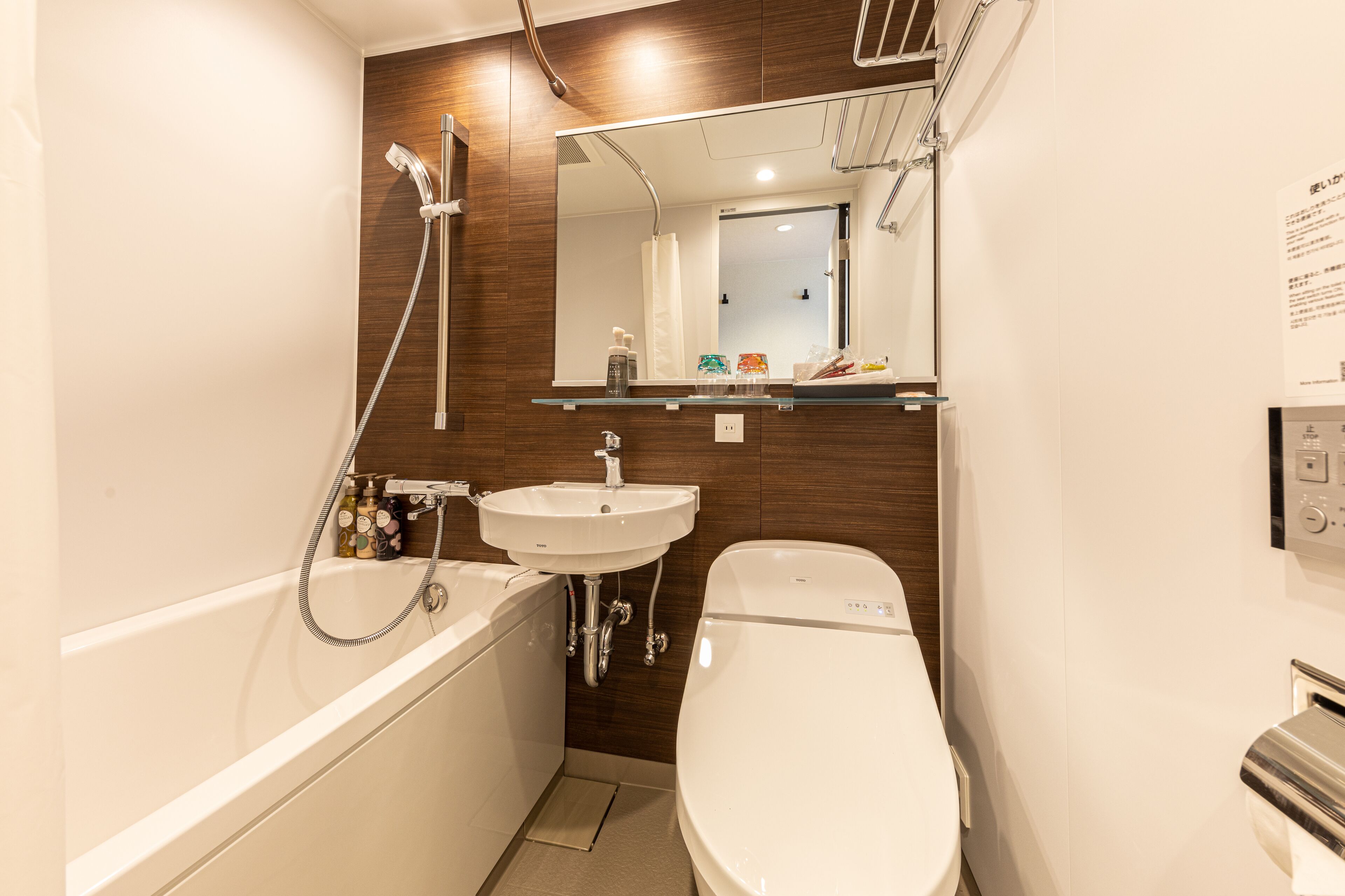 A modern bathroom with a bathtub, toilet, and sink.