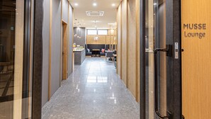 A modern lounge area with a polished floor, wooden paneling, and a sign reading "MUSSE Lounge". - Hotel Musse Kyoto Shijo Kawaramachi Meitetsu (Kyoto)