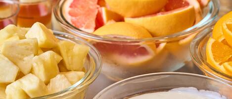 Tazones de fruta con piña, pomelo y rodajas de naranja.