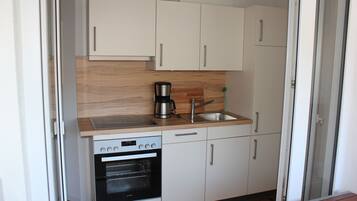 Fridge, stovetop, dishwasher, coffee/tea maker