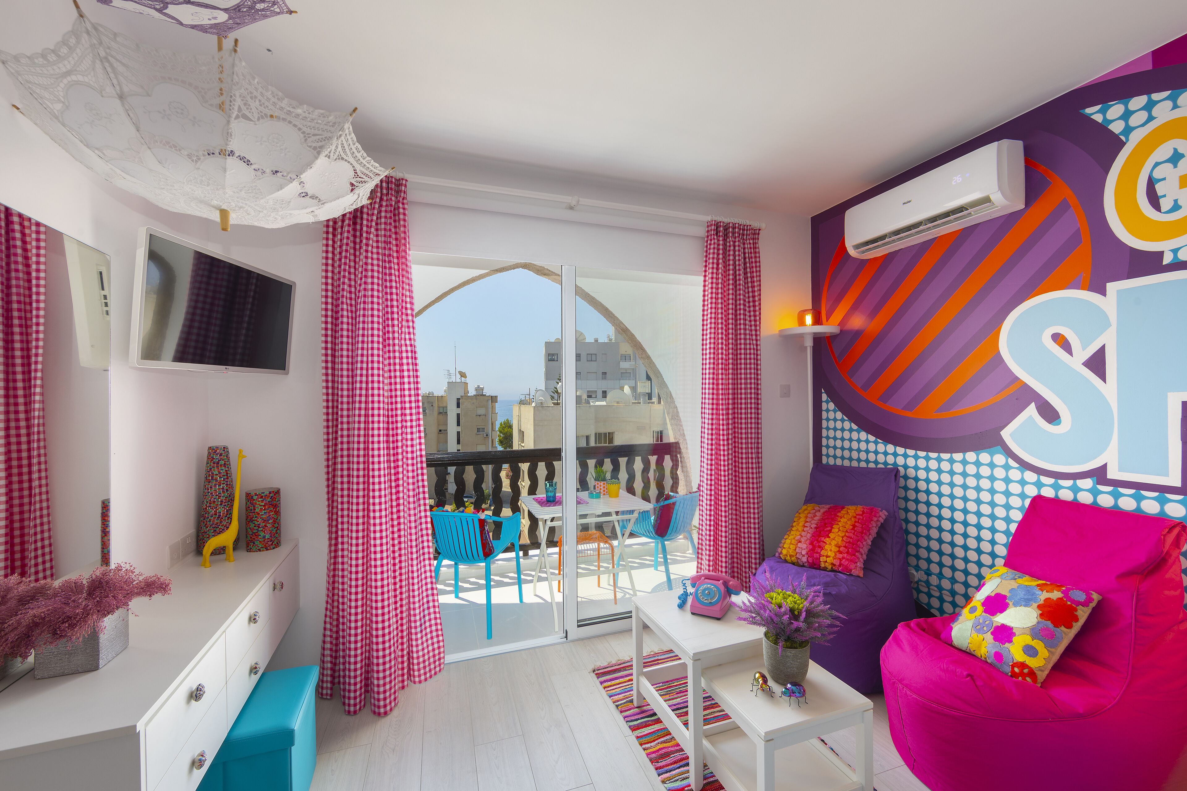 Pop Art Indulgence Studio (A402) | Living area | 65-inch flat-screen TV with digital channels, TV, books